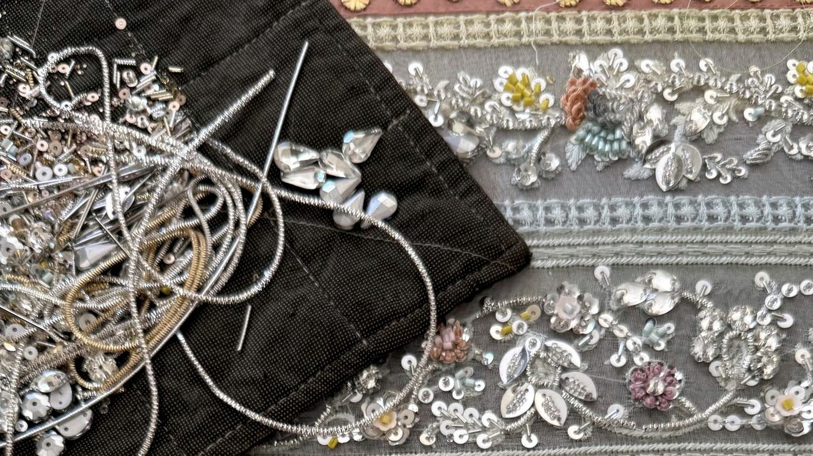 Hands finishing Lolo embroidery by hand